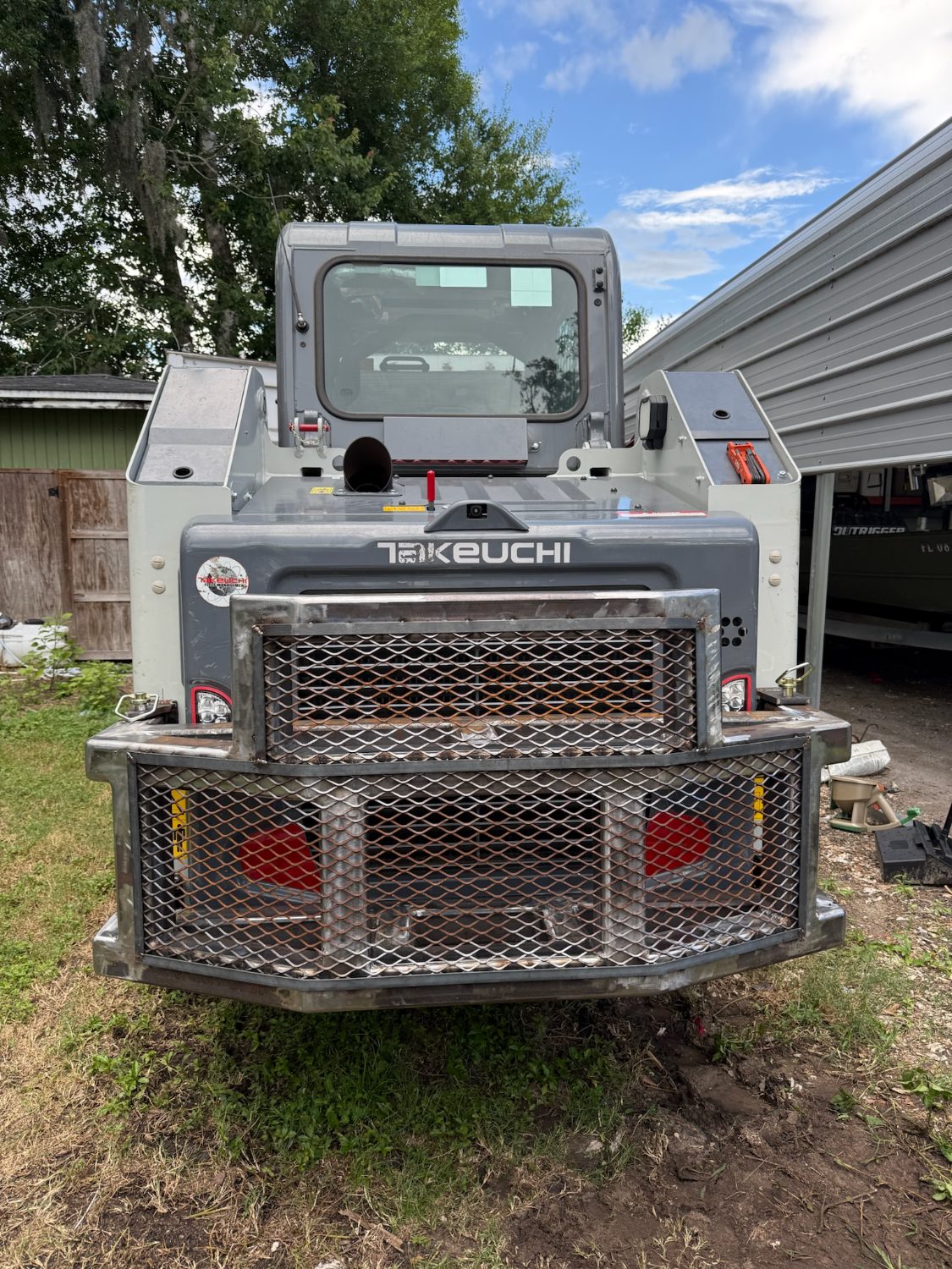 Custom steel brush guard on a skid steer